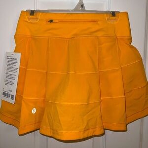 Lululemon tennis/golf skirt, orange, size 0, never worn, tag still on.